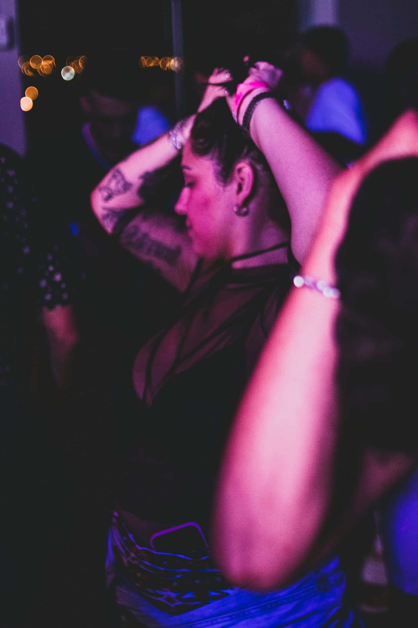 Motion-blurred dancer under purple lights